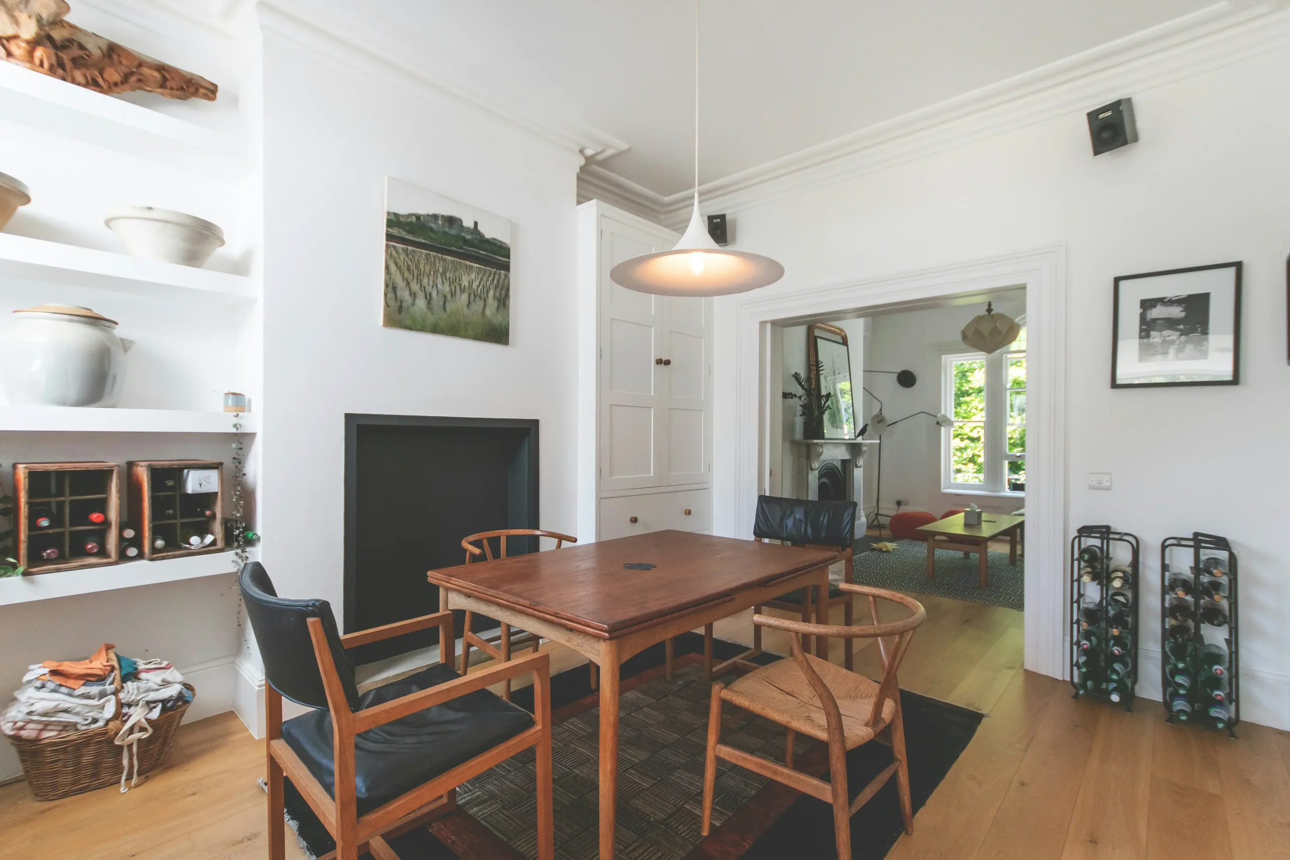Elegant modern dining room with vintage accents, featuring timeless furniture and curated antique decor.